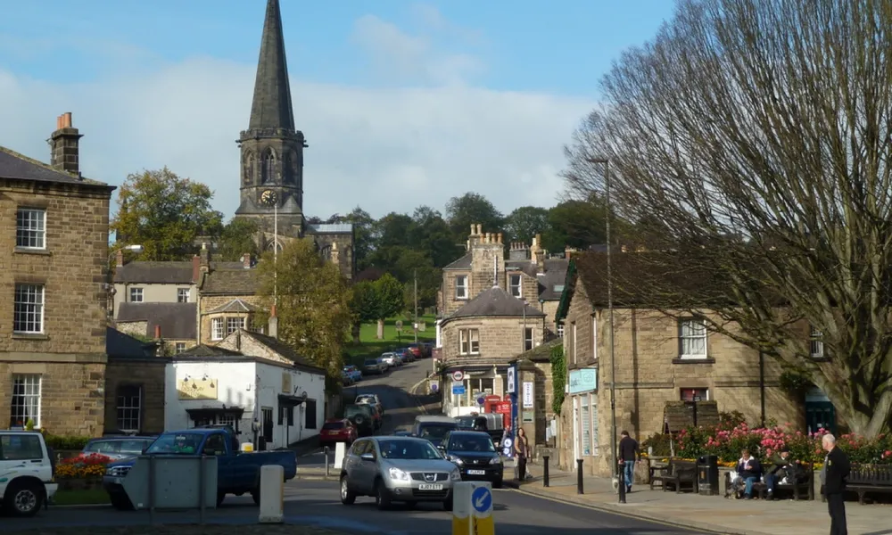 A street in Bakewell with the parish church spire behind