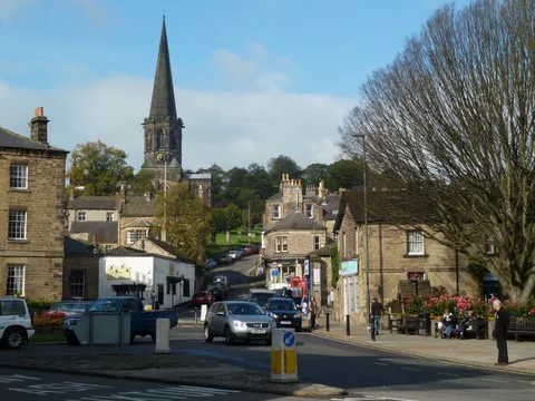 A street in Bakewell with the parish church spire behind