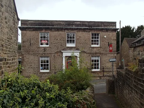 A stone building in Hathersage village centre