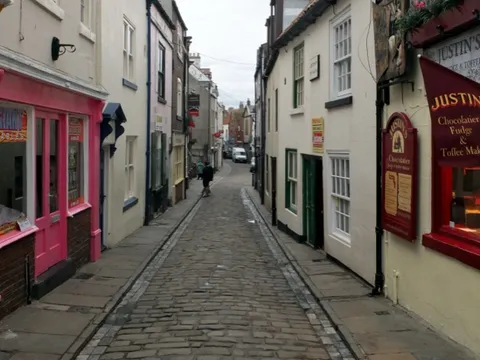 The cobbled lane of Church Street, Whitby, lined with small shops